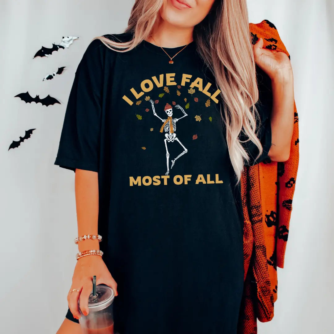 White T-shirt featuring a skeleton design with "I Love Fall Most of All" text, by Winks Design Studio, LLC.
