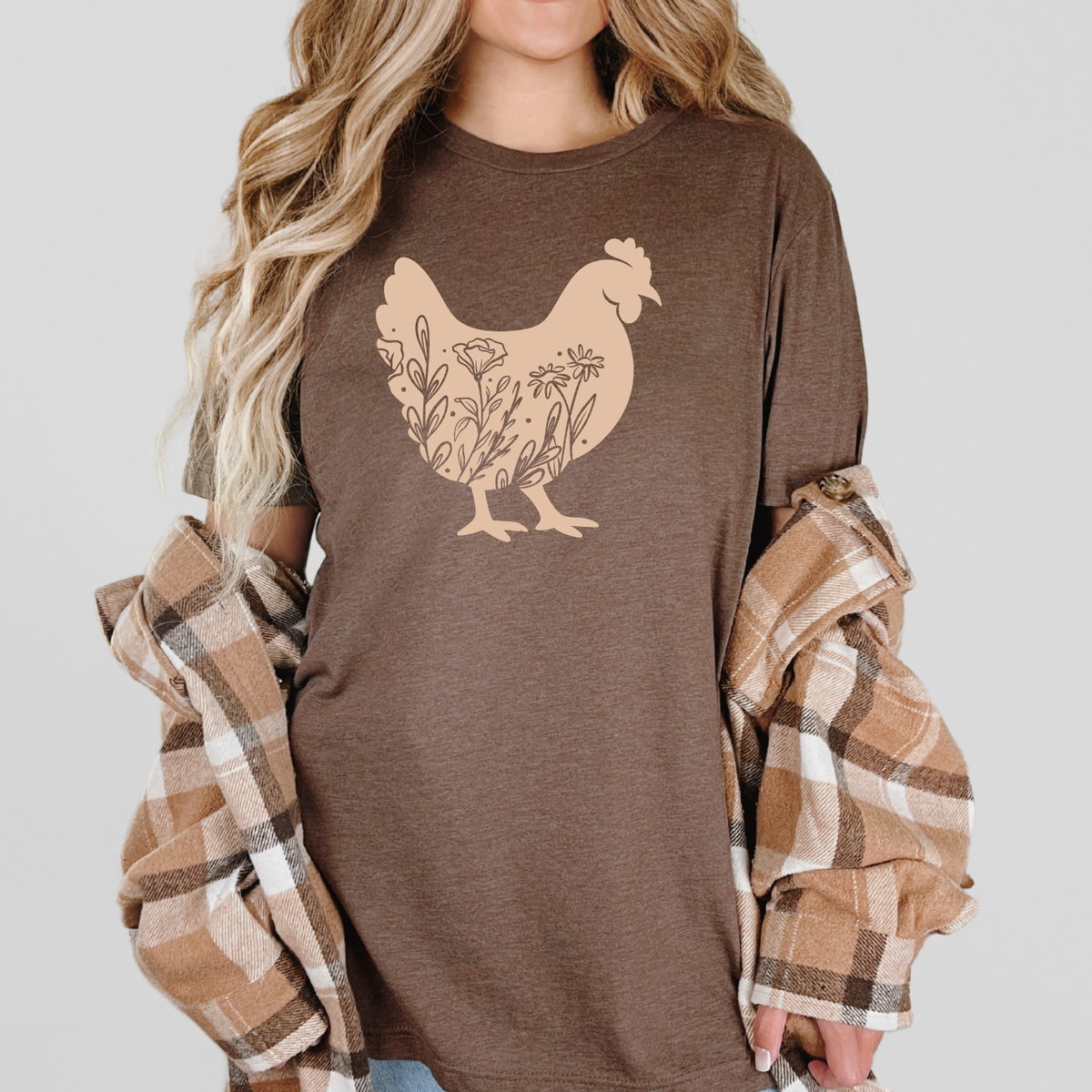 Wildflower hen graphic on farmhouse-style tee shirt by Winks Design Studio, LLC, featuring natural floral and hen illustration.