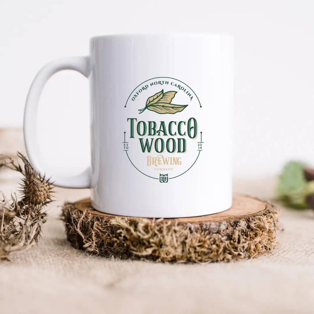 Tobacco Wood Brewing ceramic mug with a glossy finish and sturdy handle, designed by Winks Design Studio, LLC.