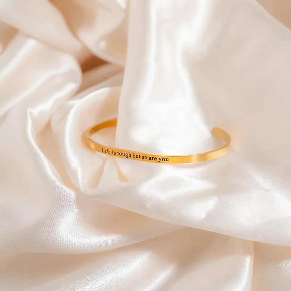 Gold PVD engraved bangle bracelet with "Life is Tough So Are You" inscription, stylish jewelry from Winks Design Studio.