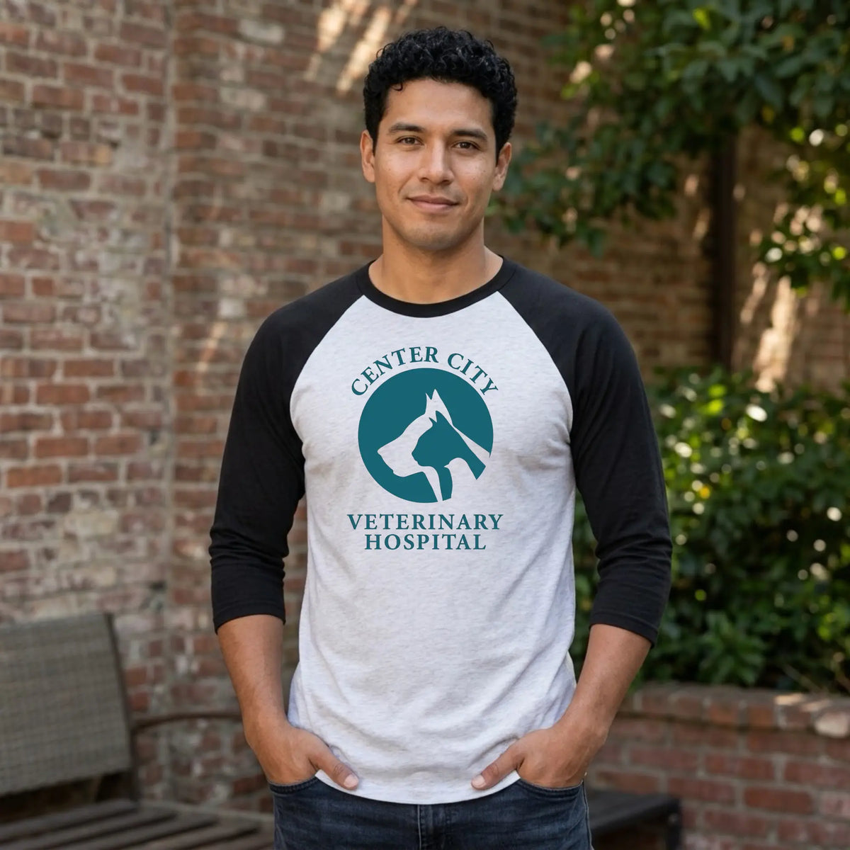 Winks Design Studio Center City Vet raglan baseball T-shirt with navy and white sleeves and a centered graphic design.