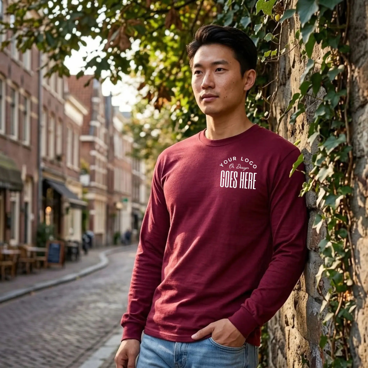 Maroon custom long sleeve t-shirt with a white "Your Logo or Design Goes Here" left chest placeholder print