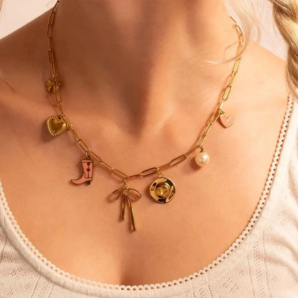 18K gold long bow charm from Winks Design Studio, LLC, featuring a detailed bow design on a jewelry charm.