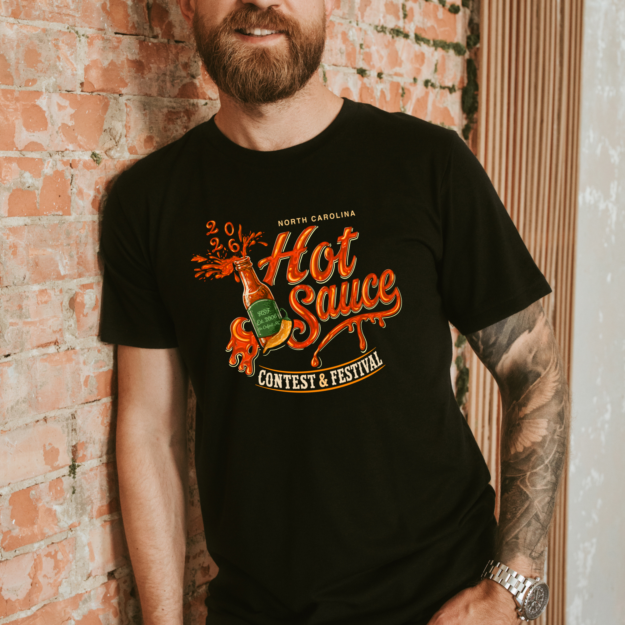 Winks Design Studio NC Hot Sauce Festival T-shirt featuring colorful hot sauce bottle graphic on front, casual wear for hot sauce fans.