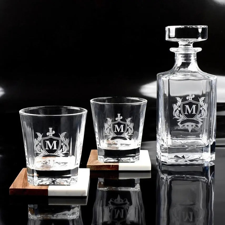 Custom whiskey decanter set from Winks Design Studio, LLC featuring a glass decanter with stopper and matching glasses.