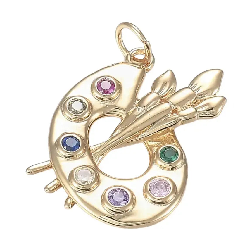 Gold and zirconia artist palette charm featuring detailed paintbrush and color accents, crafted by Winks Design Studio LLC.