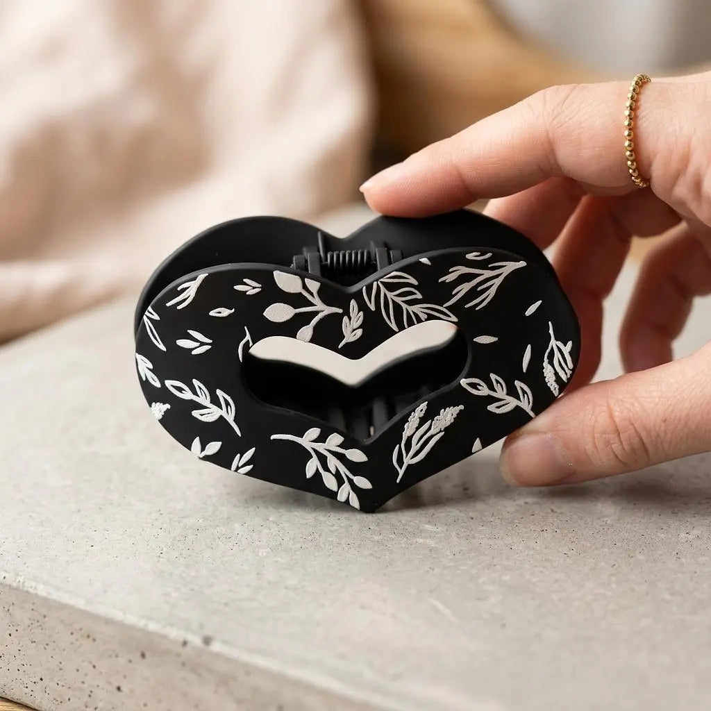 Winks Design Studio LLC Sage and Stem Heart Claw Clip with intricate leaf and heart design, made of durable material for hair styling.