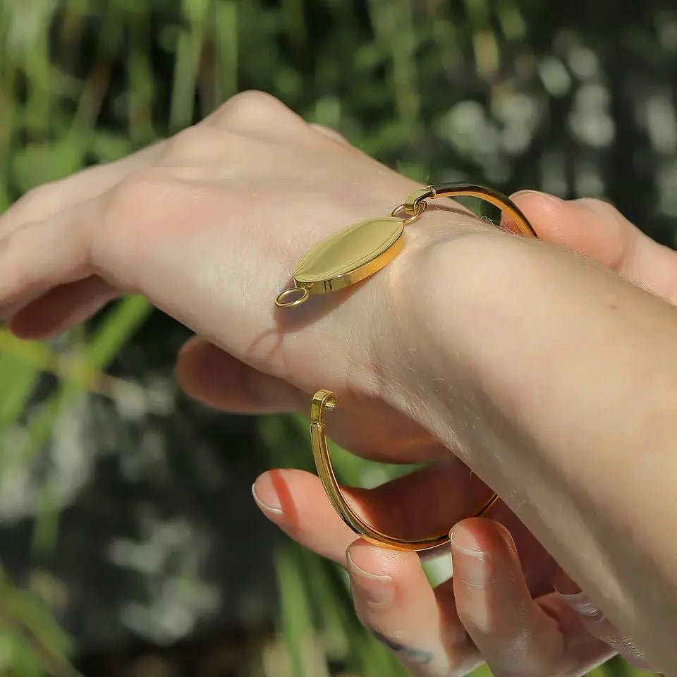 Engravable oval gold bracelet by Winks Design Studio, LLC, featuring a sleek design and personalized engraving surface.