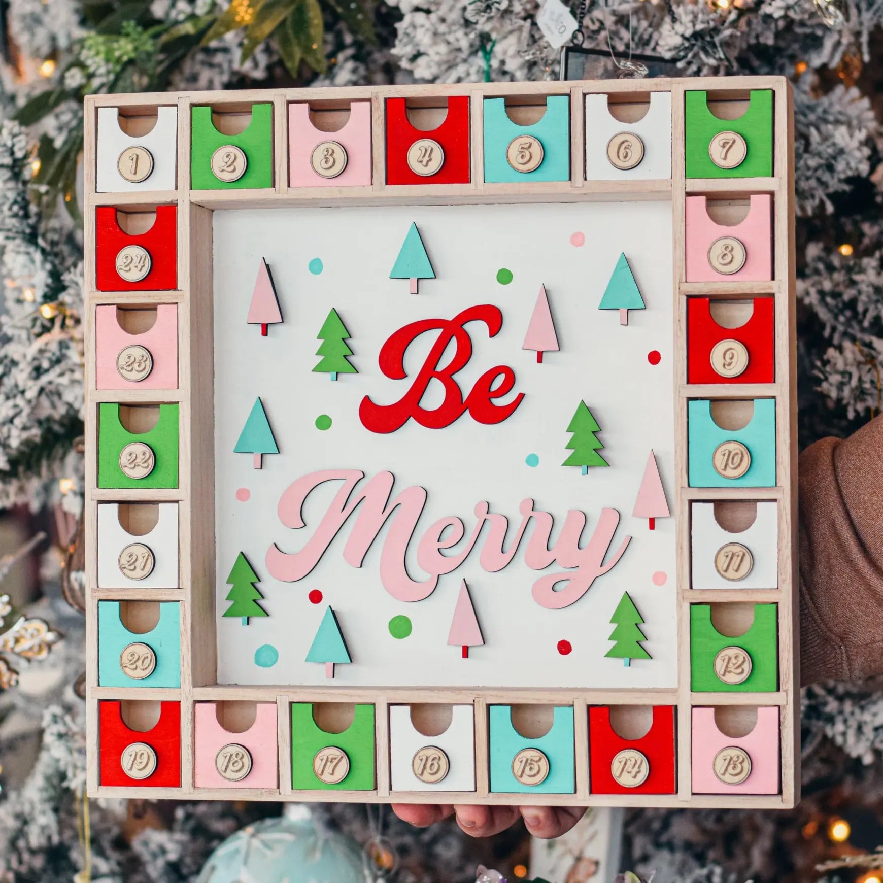 Be Merry Advent Calendar by Winks Design Studio, LLC featuring festive holiday-themed compartments and decorative holiday motifs.