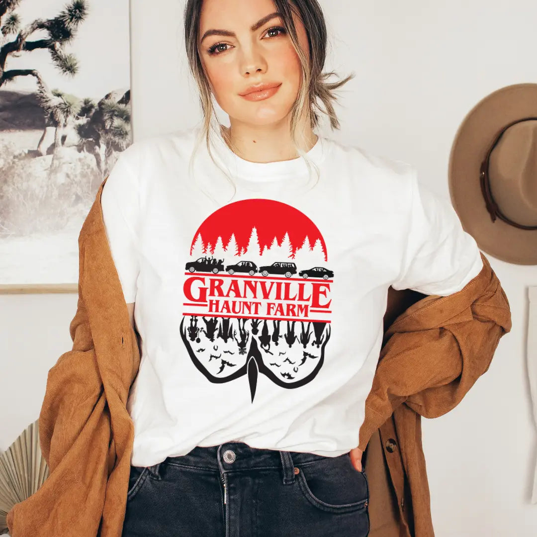 Winks Design Studio LLC Granville Haunt Farm upside-down T-shirt featuring spooky farm scene in black and white.