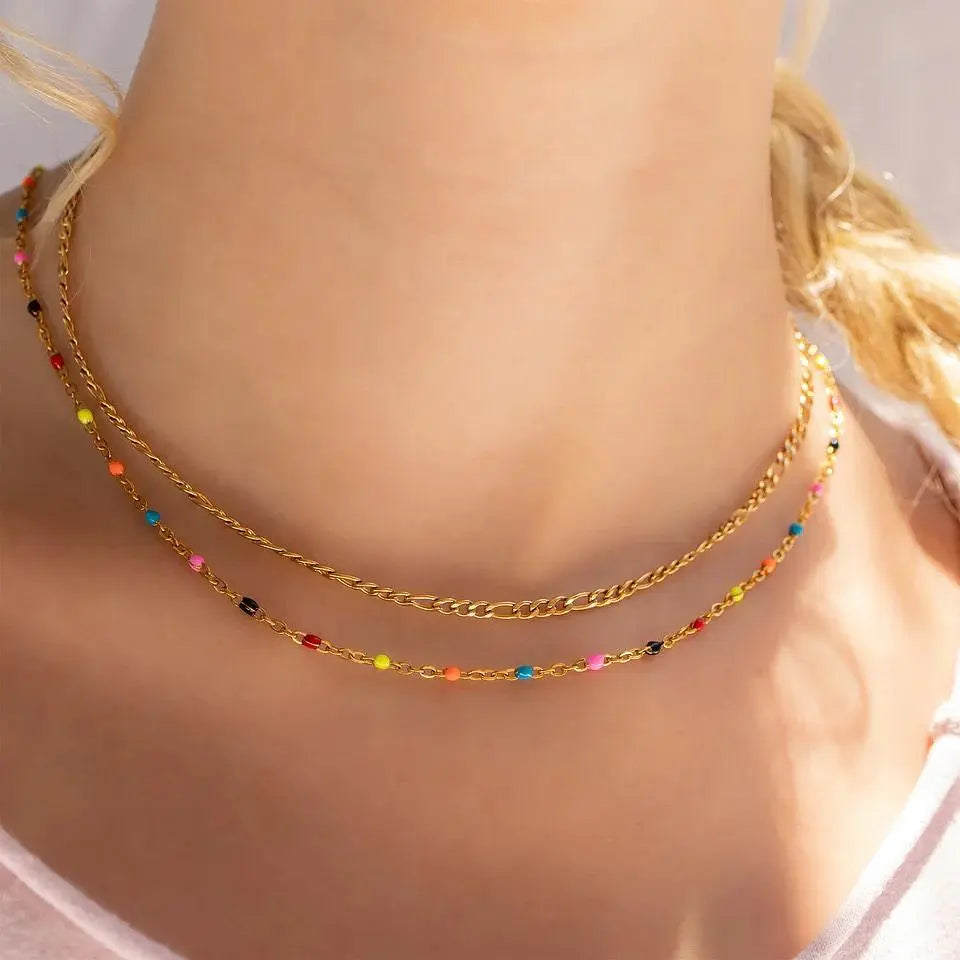 18K gold multi confetti chain necklace from Winks Design Studio, LLC featuring colorful, layered gold links on a white background.