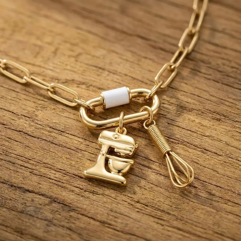 18K gold PVD stainless steel whisk charm from Winks Design Studio, LLC, jewelry charm with detailed whisk design.