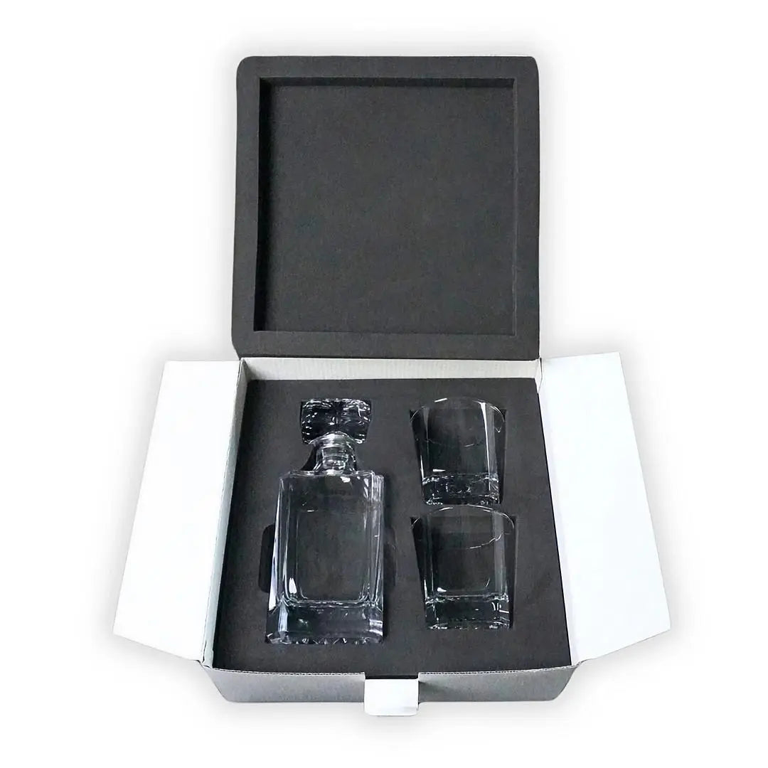 Winks Design Studio LLC custom whiskey decanter set with glass stopper and matching glasses on a wooden surface.