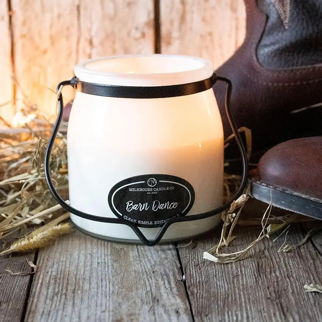 Milkhouse Candle 16oz Butter Jar Candle from Winks Design Studio, LLC featuring a rustic barn dance scene on the wax surface.