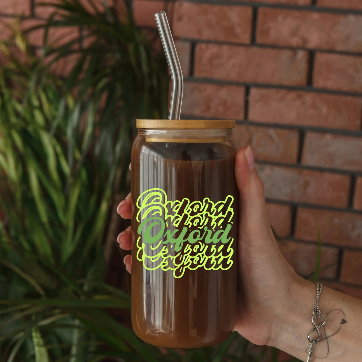 Clear glass beer can with Oxford Script design, 20oz capacity, by Winks Design Studio, LLC, shown filled with beverage.