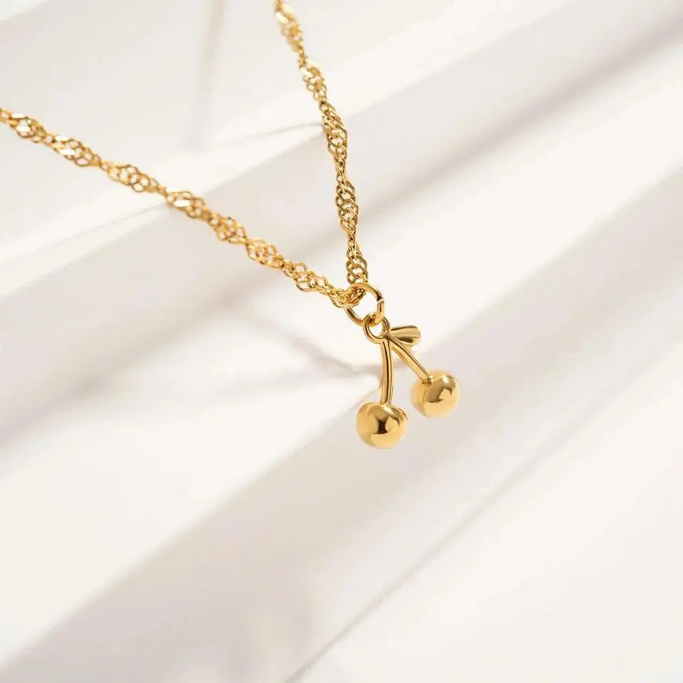 18K gold cherry charm by Winks Design Studio, LLC, featuring a detailed, shiny cherry design suitable for jewelry or charm bracelets.