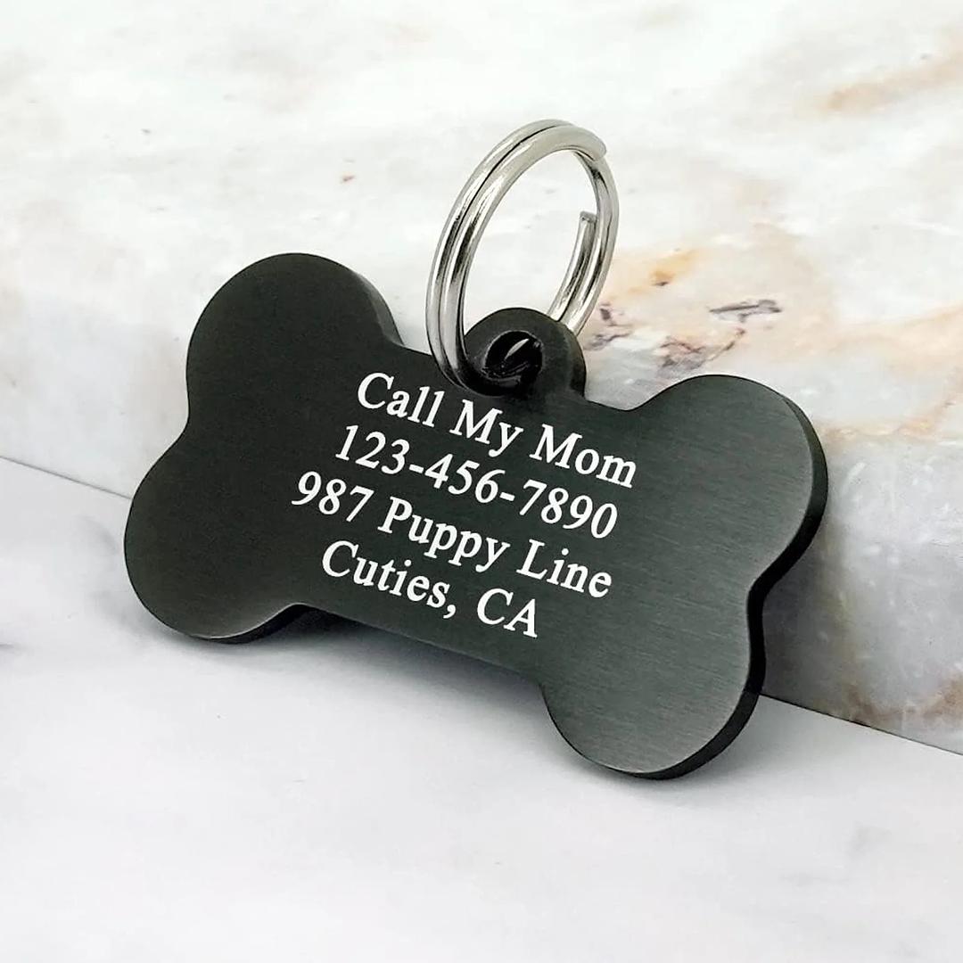 Custom engraved aluminum pet ID tag with bone shape from Winks Design Studio, LLC, featuring engraved pet details and durable design.