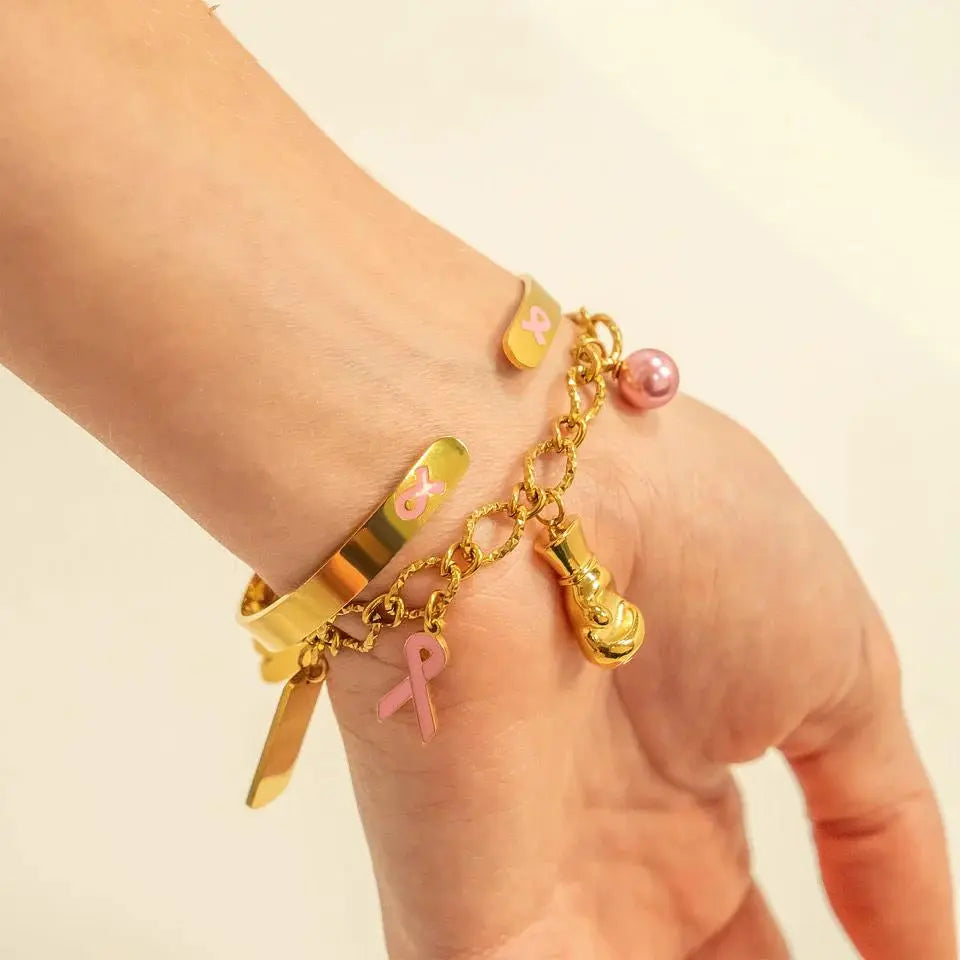 18K gold pink pearl charm by Winks Design Studio featuring a delicate pink pearl and intricate gold detailing.