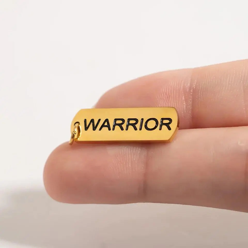 18K gold warrior charm from Winks Design Studio,LLC featuring detailed warrior figure with intricate design and polished finish.