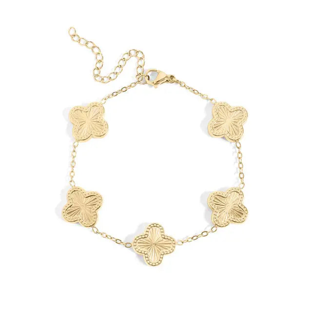 Gold four-leaf clover charm bracelet with delicate links, featuring a lucky clover pendant, by Winks Design Studio, LLC.