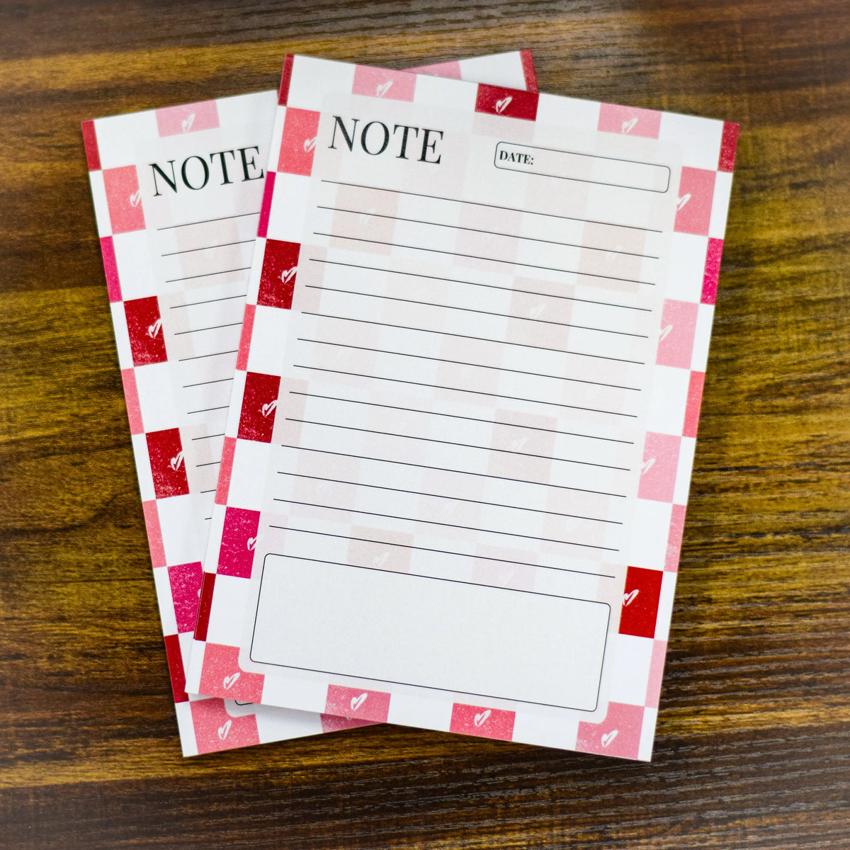 Five 5x7 checkerboard heart notepads with pink and white covers from Winks Design Studio, LLC, displayed on a flat surface.