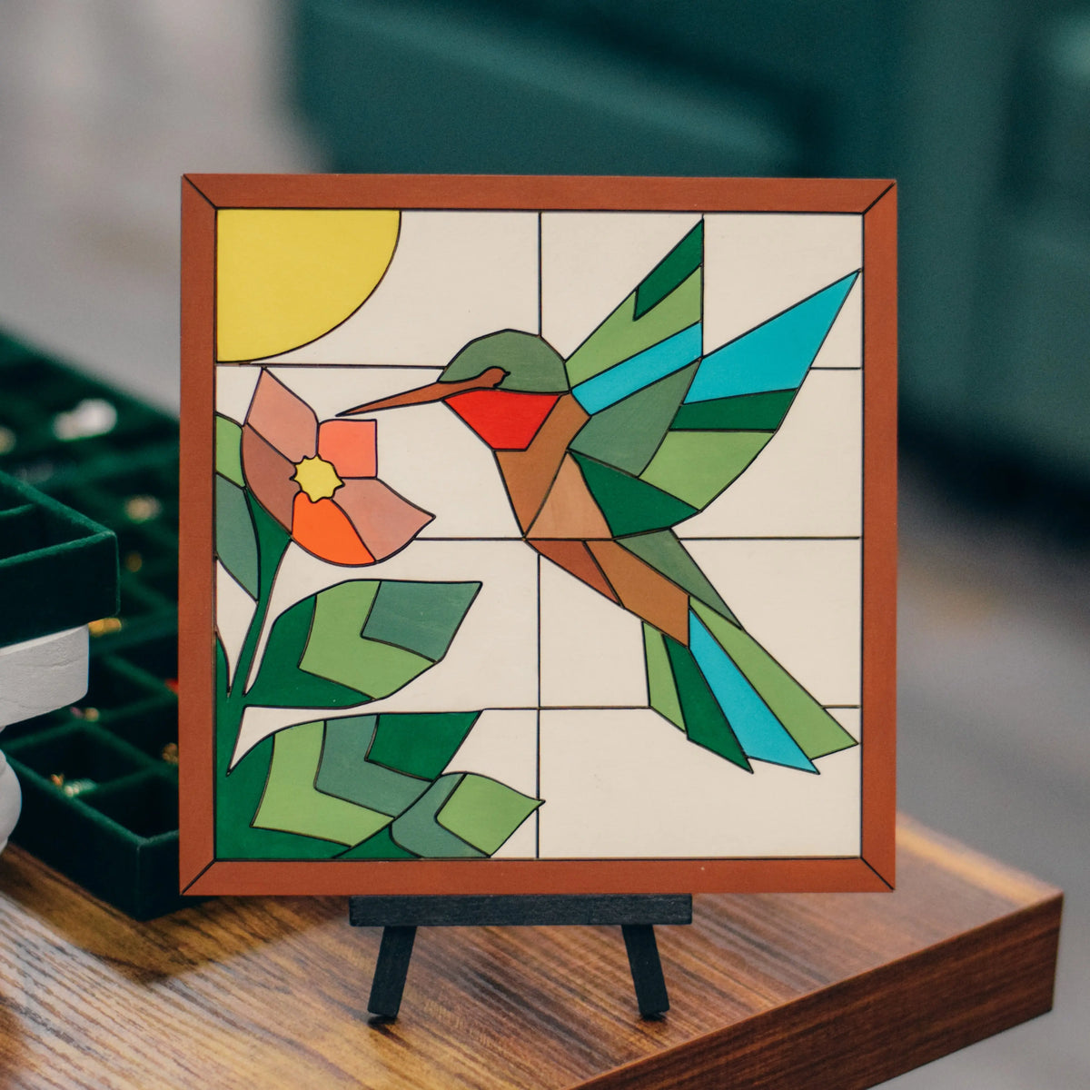 DIY hummingbird wooden mosaic sign kit from Winks Design Studio, LLC, featuring colorful mosaic tiles and craft workshop materials.