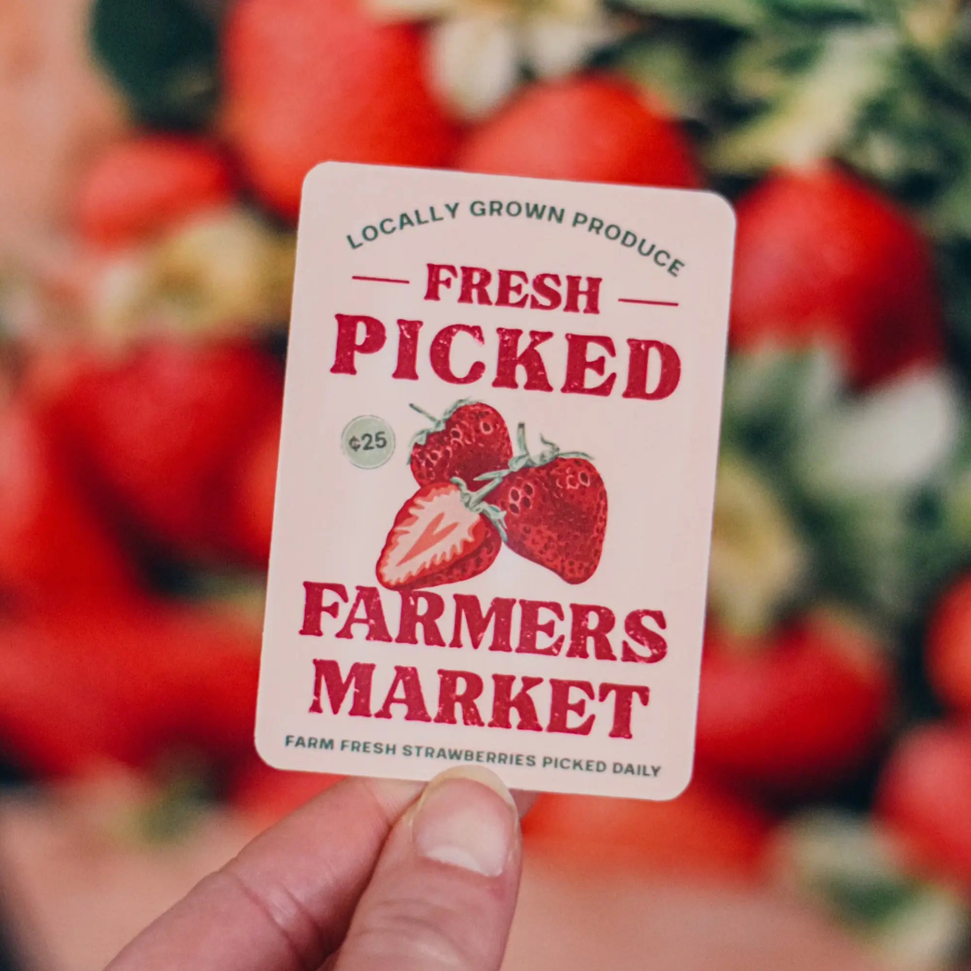 Fresh picked strawberry sticker from Winks Design Studio, LLC, featuring vibrant red strawberries and green leaves.
