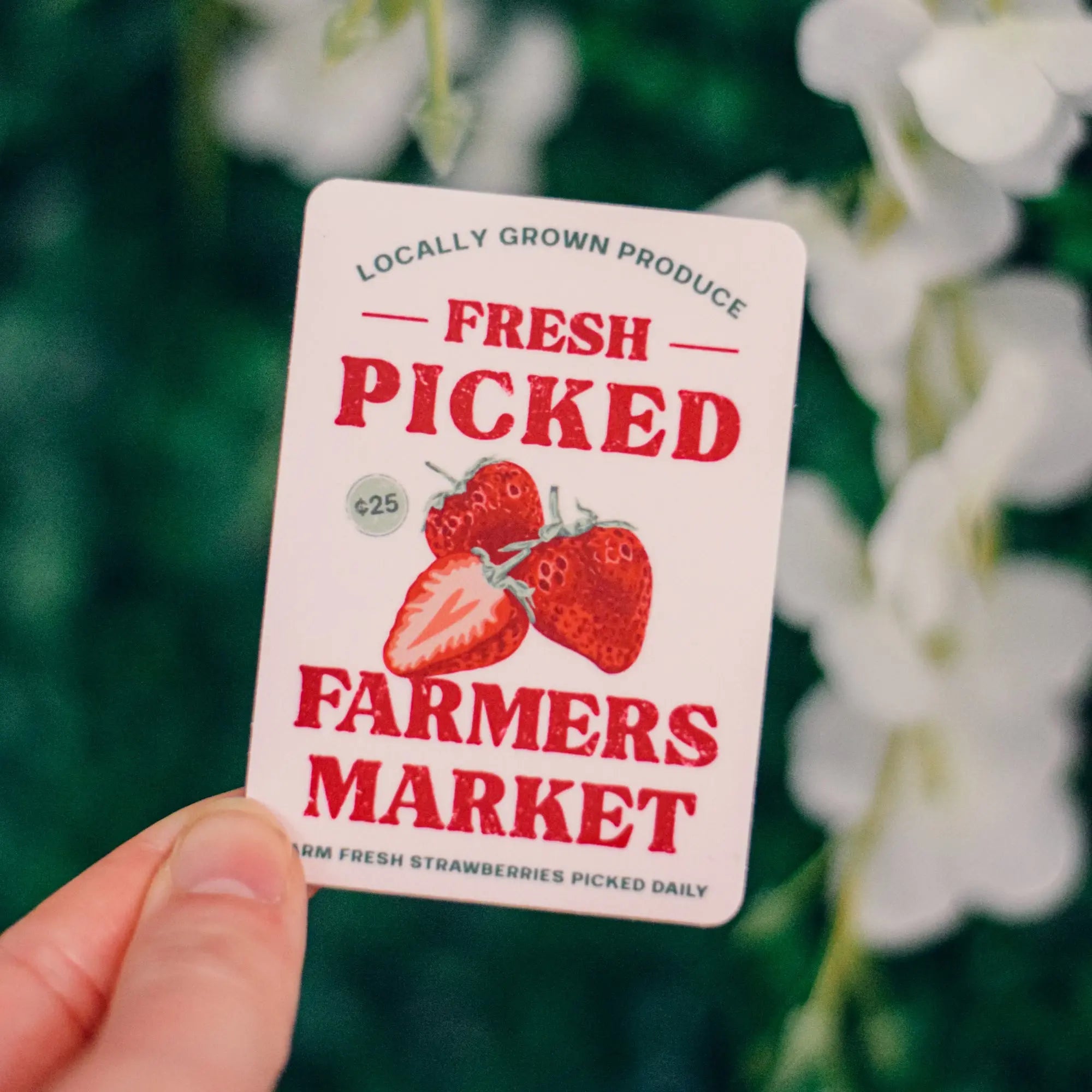 Winks Design Studio LLC fresh picked strawberry sticker with vibrant red strawberries and green leaves on a clear background.