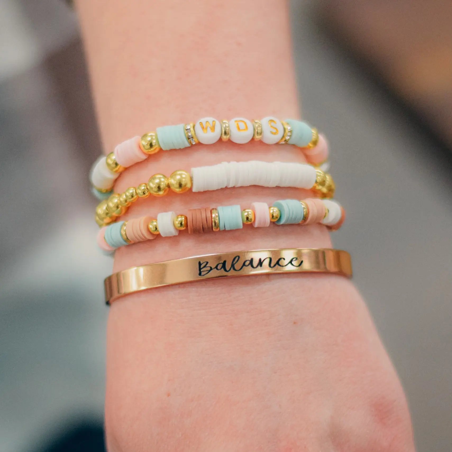 Bracelet stack workshop kit from Winks Design Studio, LLC, featuring various bracelet materials and tools for DIY jewelry making.