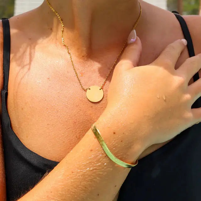 18K gold engraved circle necklace with personalized stainless steel pendant, featuring intricate design and polished finish.