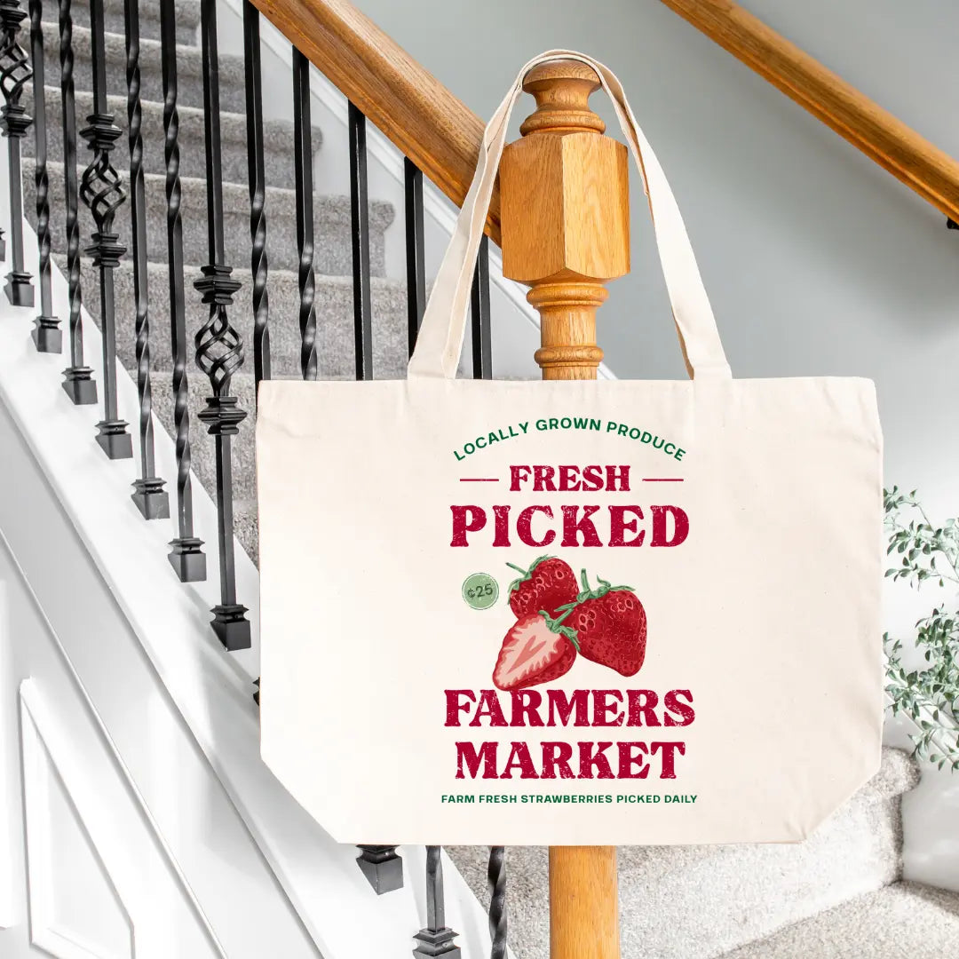 Winks Design Studio LLC Farmers Market fresh picked strawberry tote bag with colorful strawberry print and sturdy handles.