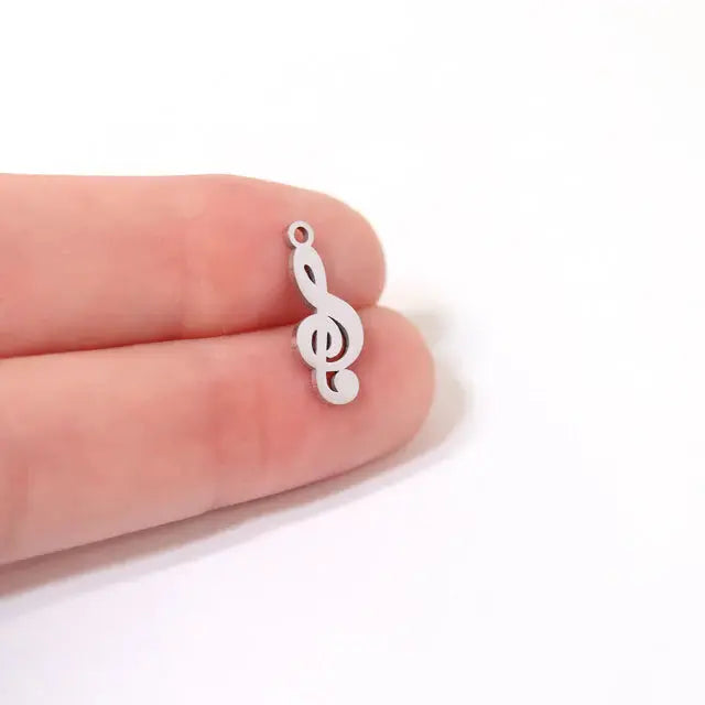 Stainless steel treble clef music charm with detailed design, crafted by Winks Design Studio, LLC.
