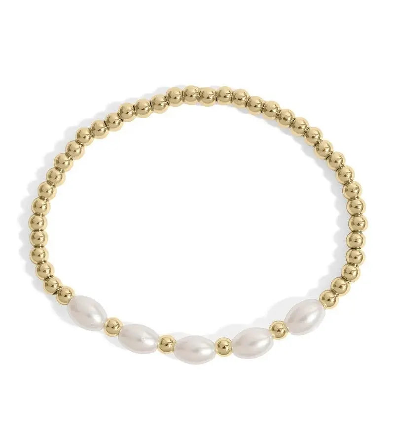 18K gold glass pearl stretch bracelet by Winks Design Studio, LLC featuring elegant pearls on a flexible gold band.