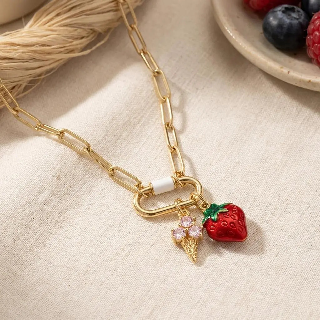 Gold enamel strawberry ice cream cone charm from Winks Design Studio, LLC, featuring vibrant red and gold summer jewelry design.