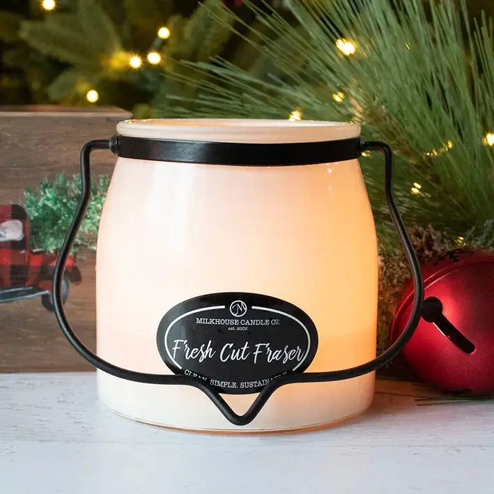 Winks Design Studio Milkhouse Candle Fresh Cut Fraser in a 16 oz butter jar with a natural candle wick and frosted glass.