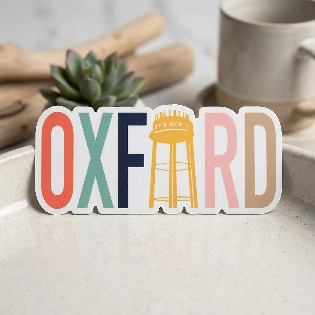 Colorful Oxford Water Tower sticker by Winks Design Studio, LLC featuring vibrant water tower illustration on a sticker.