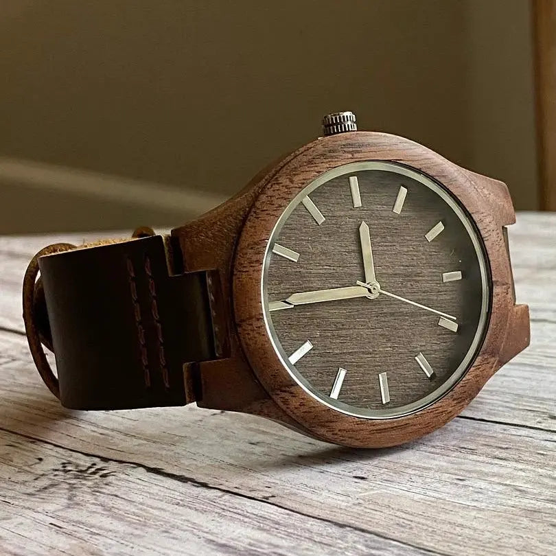 Walnut wood engraved watch by Winks Design Studio, LLC featuring a detailed wooden watch face and natural wood grain texture.
