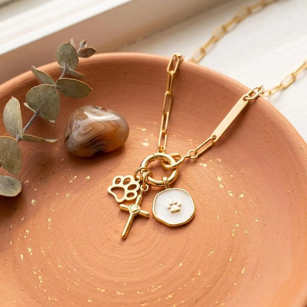 18K gold paw print charm by Winks Design Studio, LLC, featuring a detailed paw print design suitable for jewelry or charms.