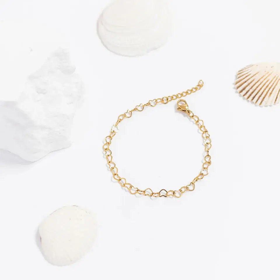 18K gold heart chain bracelet with delicate link design by Winks Design Studio, LLC.