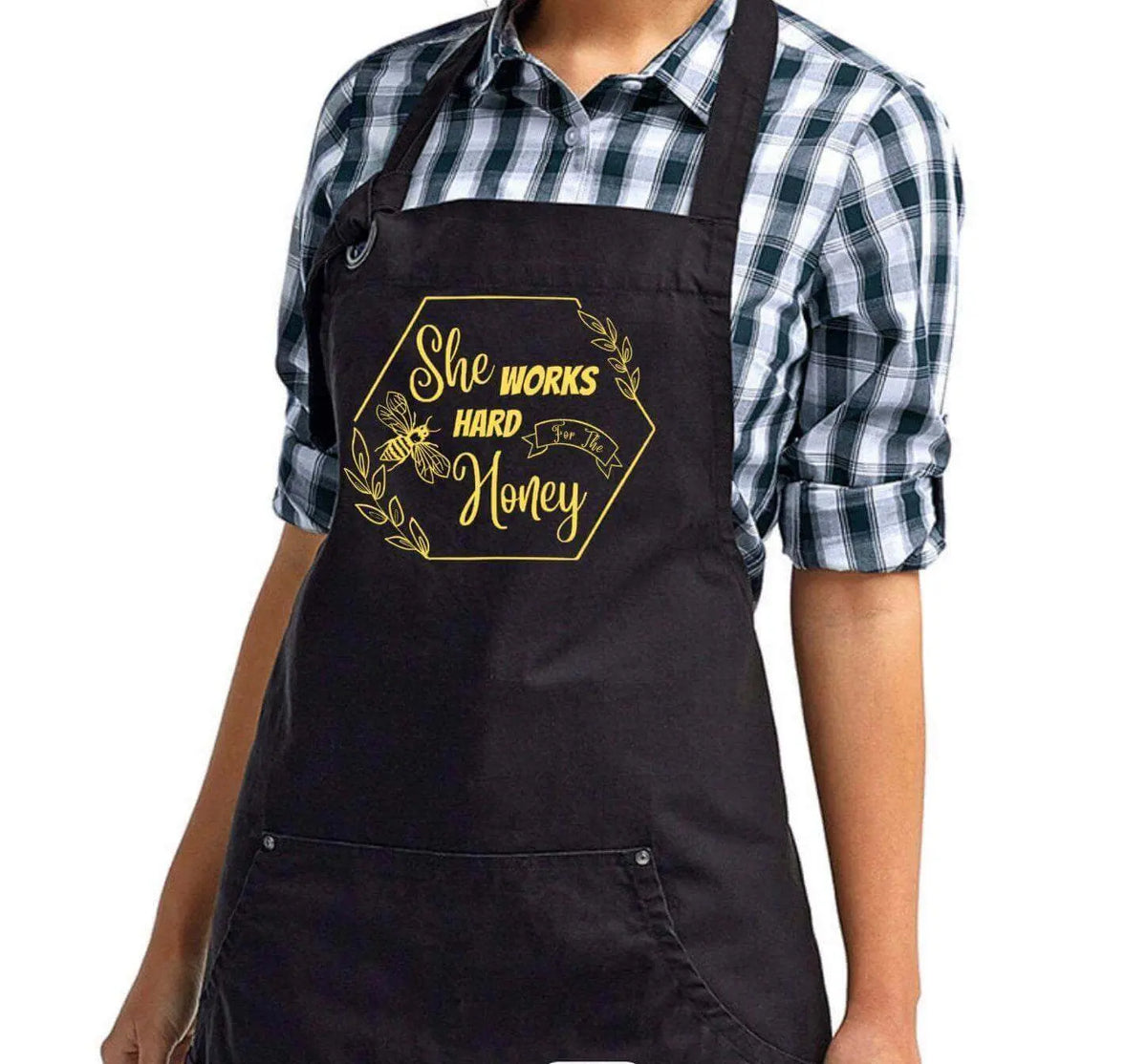 Winks Design Studio LLC "She Works Hard For The Honey" apron, beige with black text, tied waist, perfect for kitchen or gardening.