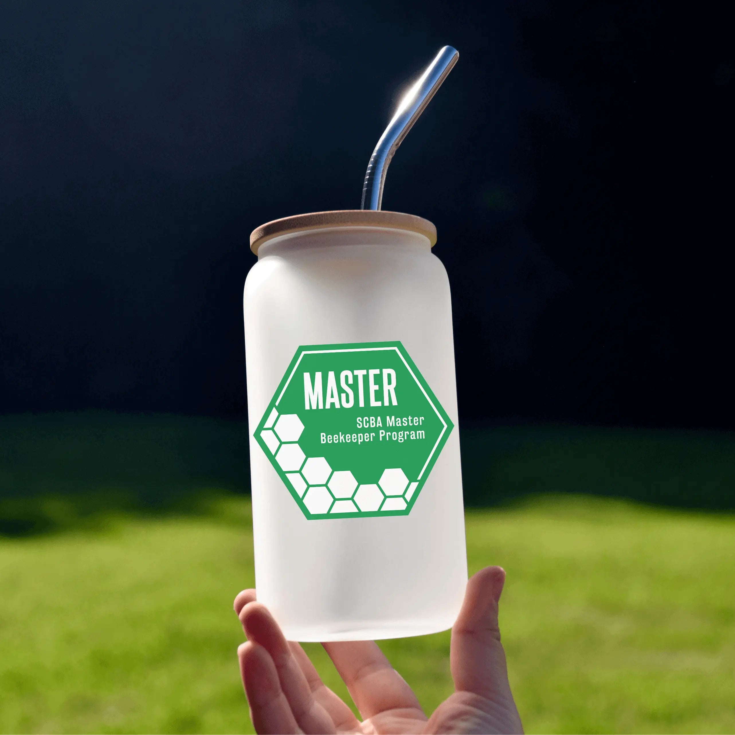 Winks Design Studio LLC beer glass featuring the SCBA Master Program logo, clear glass with printed design, cylindrical shape.