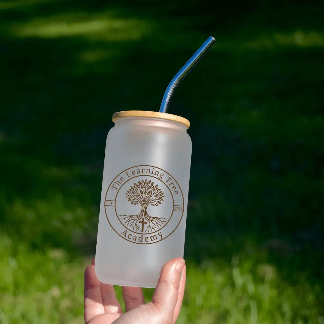 Frosted 16oz beer glass from Winks Design Studio LLC featuring The Learning Tree Academy logo and design.