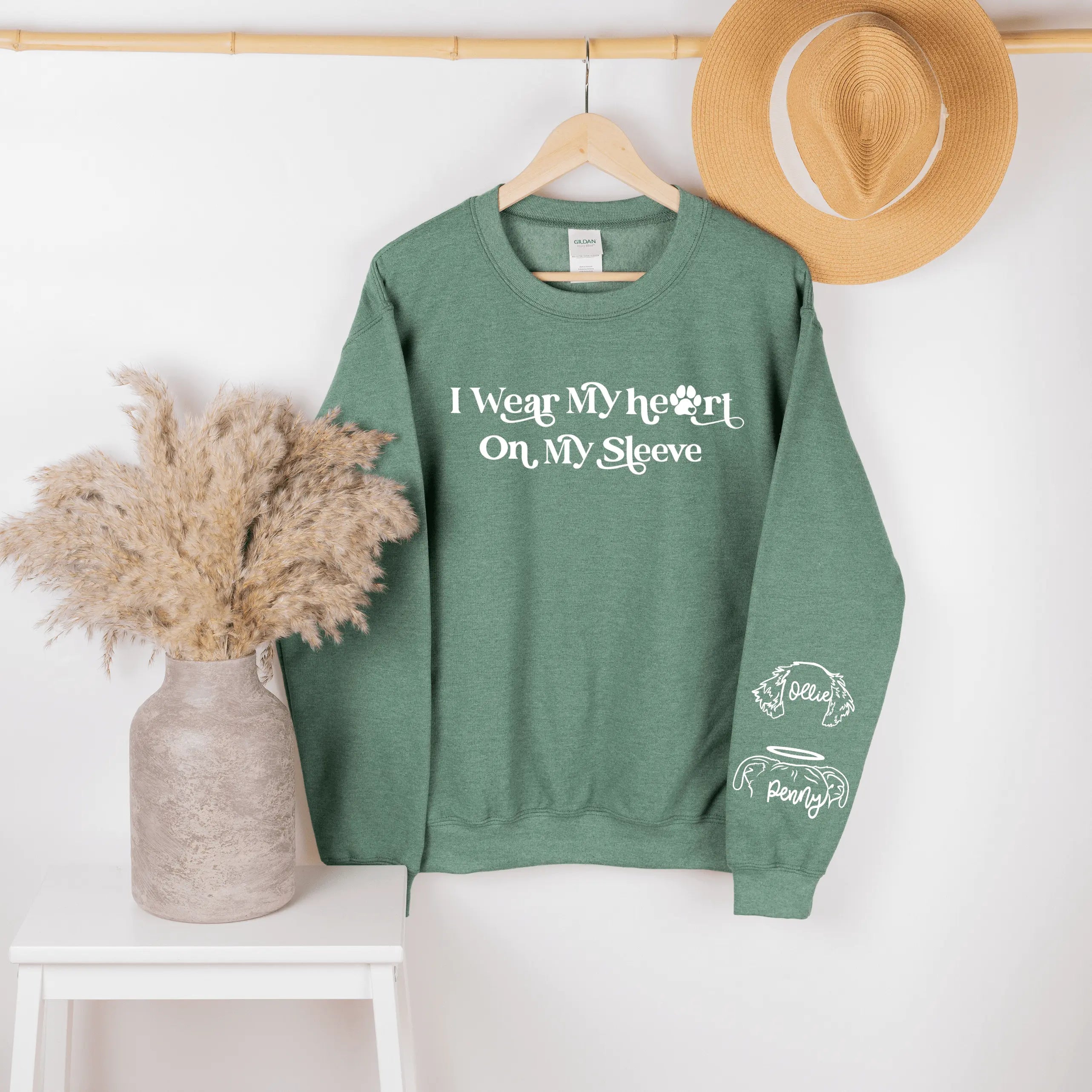 Heather royal crewneck sweatshirt by Winks Design Studio, LLC with "I Wear My Heart on My Sleeve" graphic in small print.