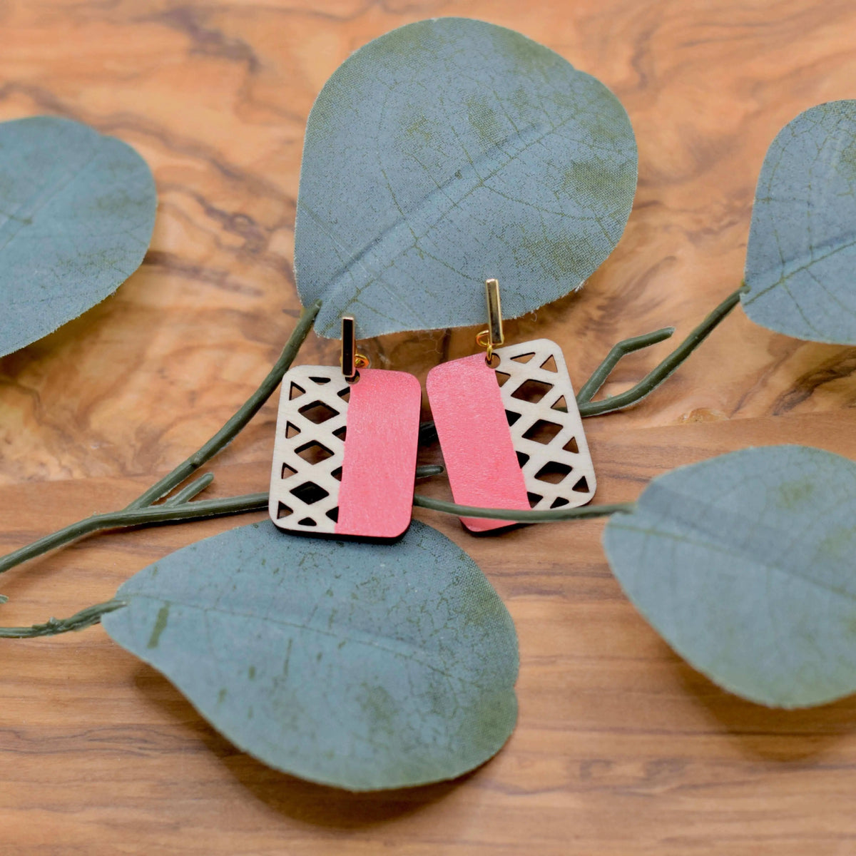 Colorful geometric wooden earrings by Winks Design Studio, LLC, featuring vibrant blue and modern angular shapes.