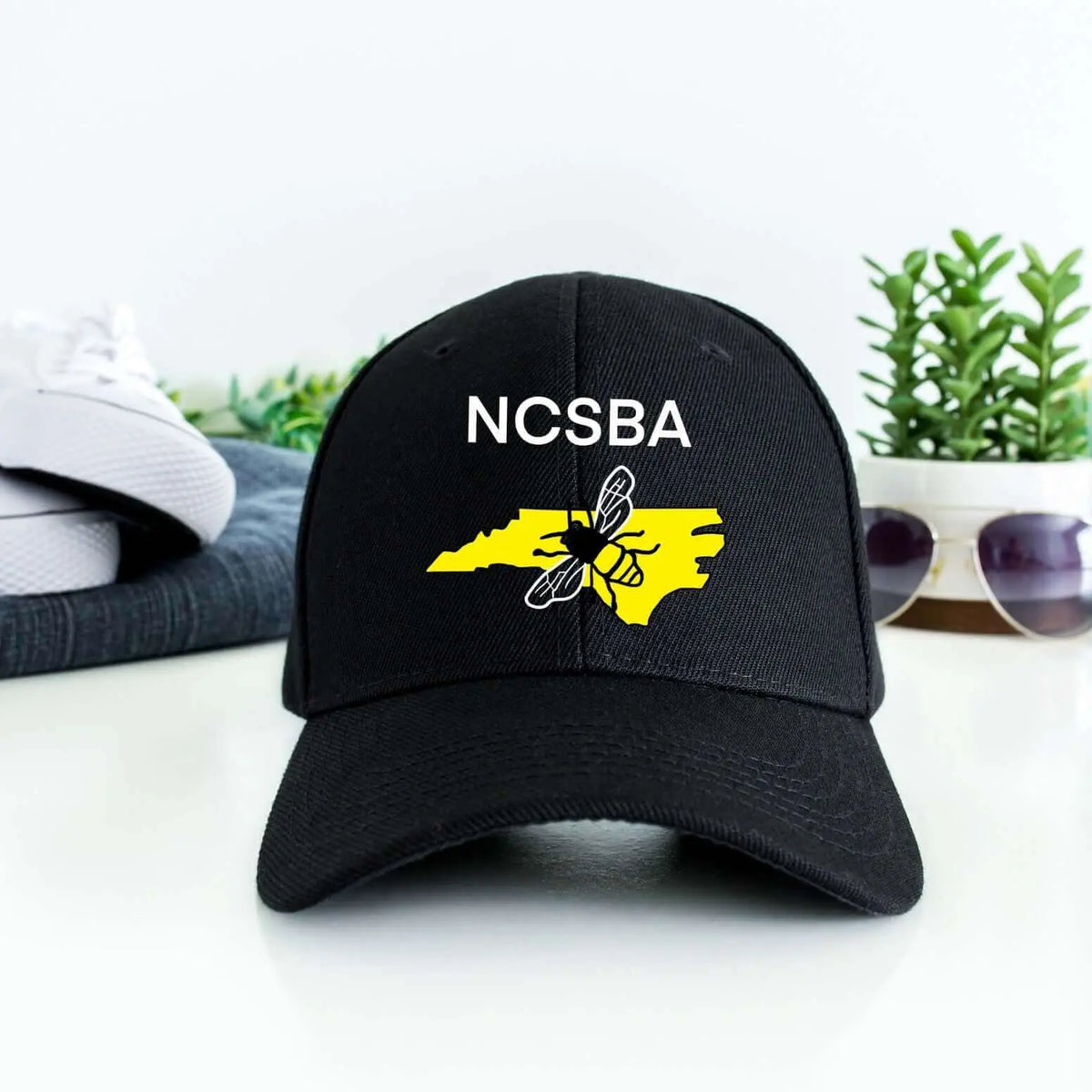 Black NCSBA custom logo hat by Winks Design Studio, LLC featuring a stylish embroidered design on the hat&