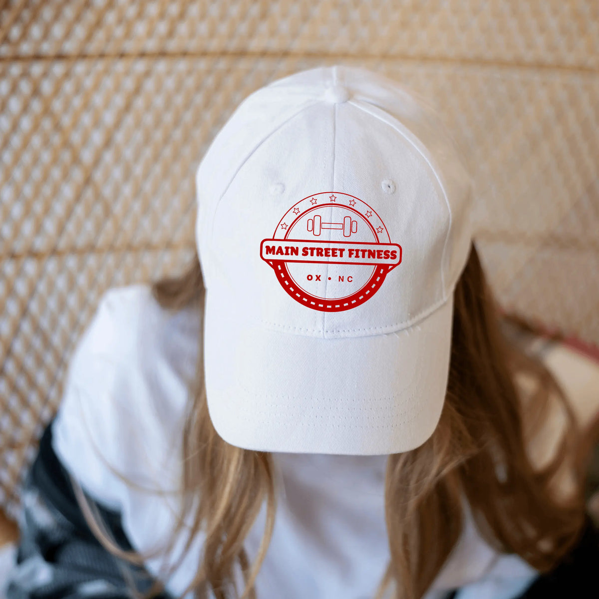 White Main Street Fitness Twill Hat by Winks Design Studio, LLC, featuring a classic hat design with a curved brim and adjustable strap.