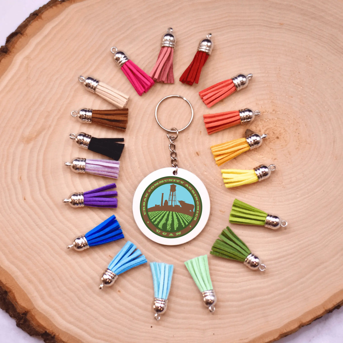 Winks Design Studio LLC UCAN keychain with colorful design and metal ring for keys or accessories.