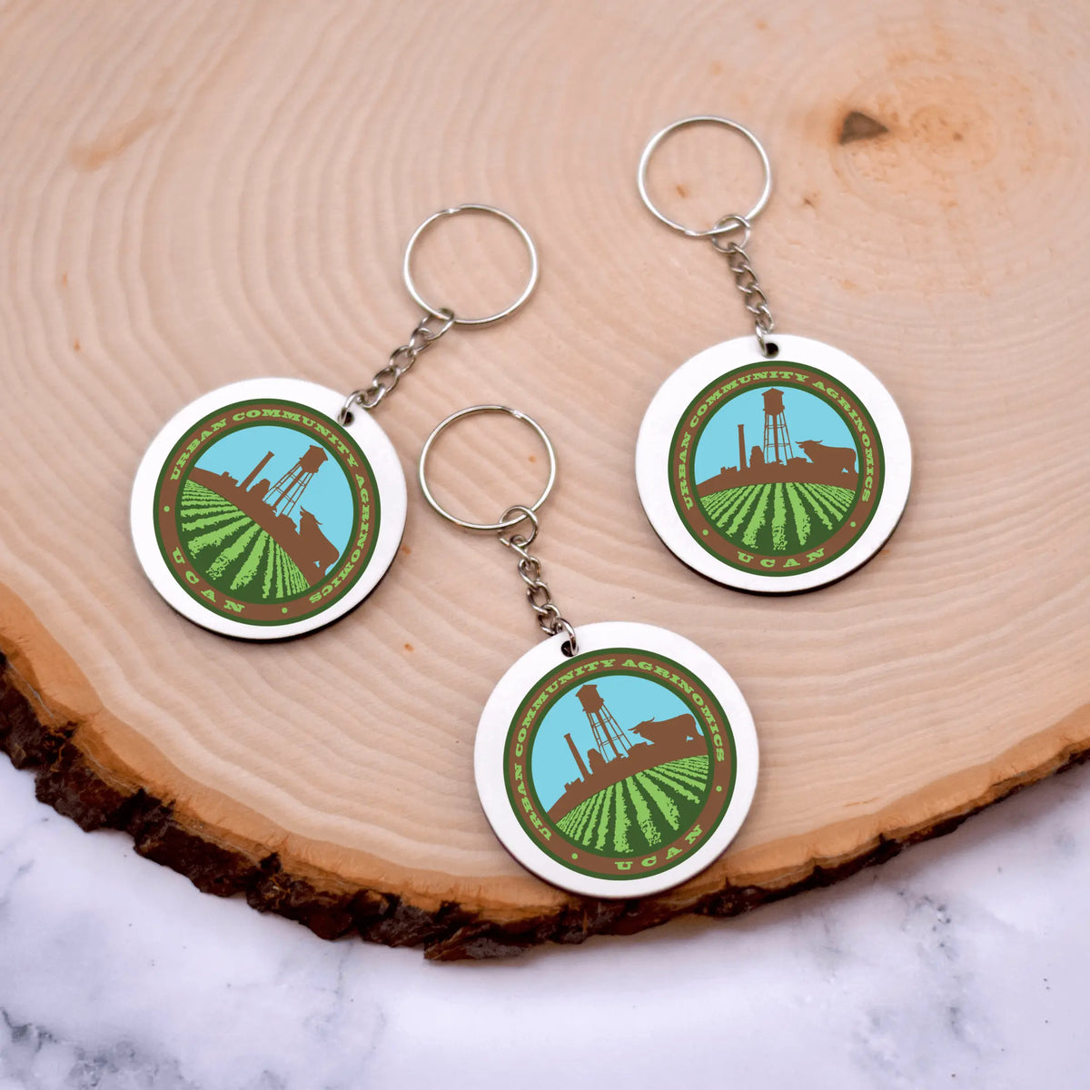 Winks Design Studio LLC UCAN keychain featuring a colorful, durable keychain with the UCAN logo and design.