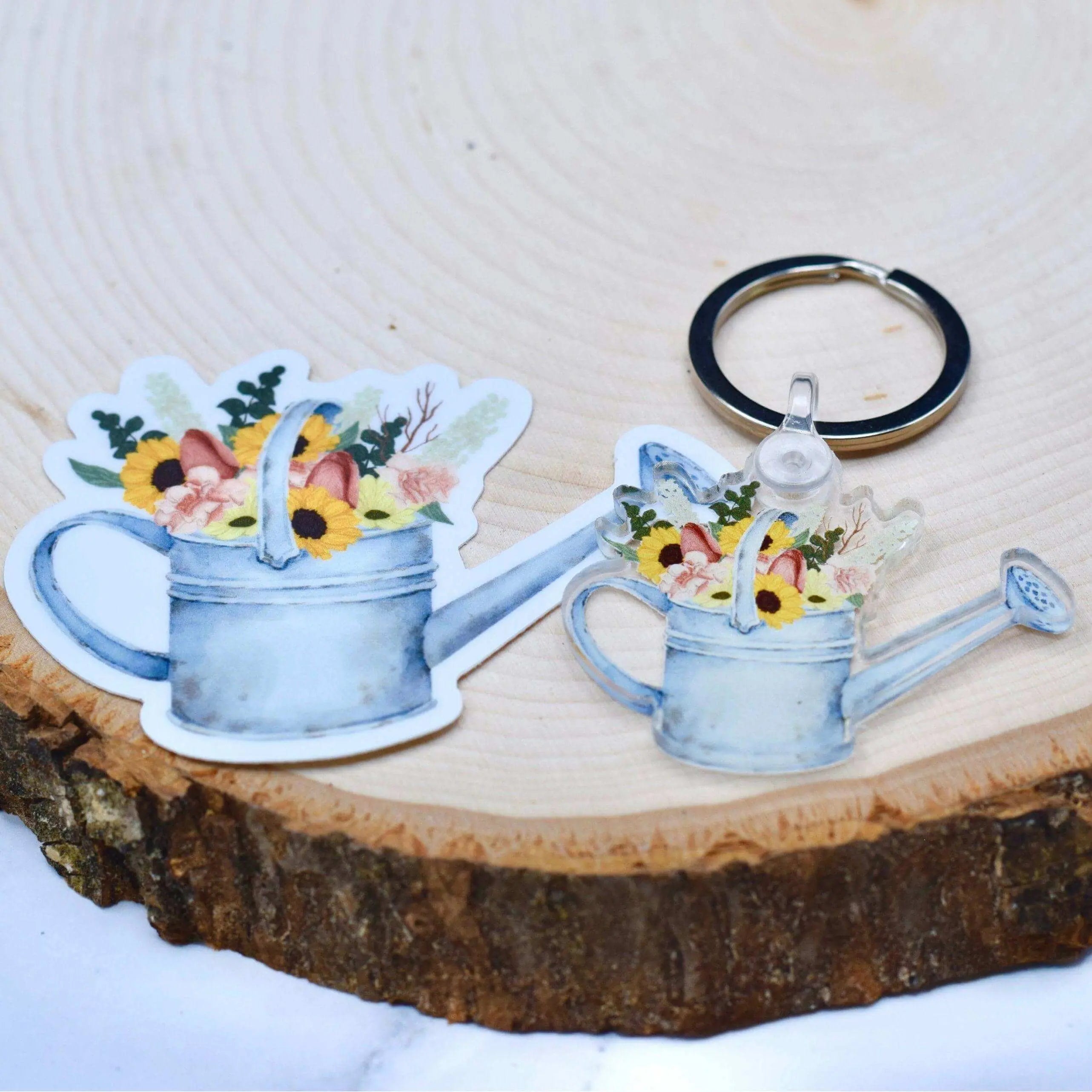 Winks Design Studio LLC watering can with flowers keychain, featuring detailed floral design and miniature watering can charm.