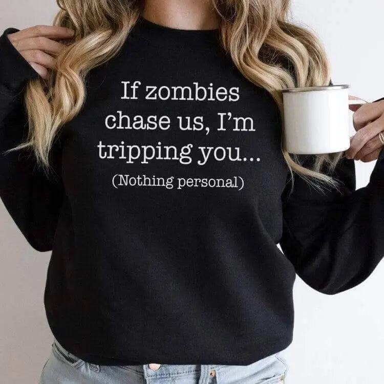 Black long sleeve shirt from Winks Design Studio LLC featuring humorous "If Zombies Chase Us I&